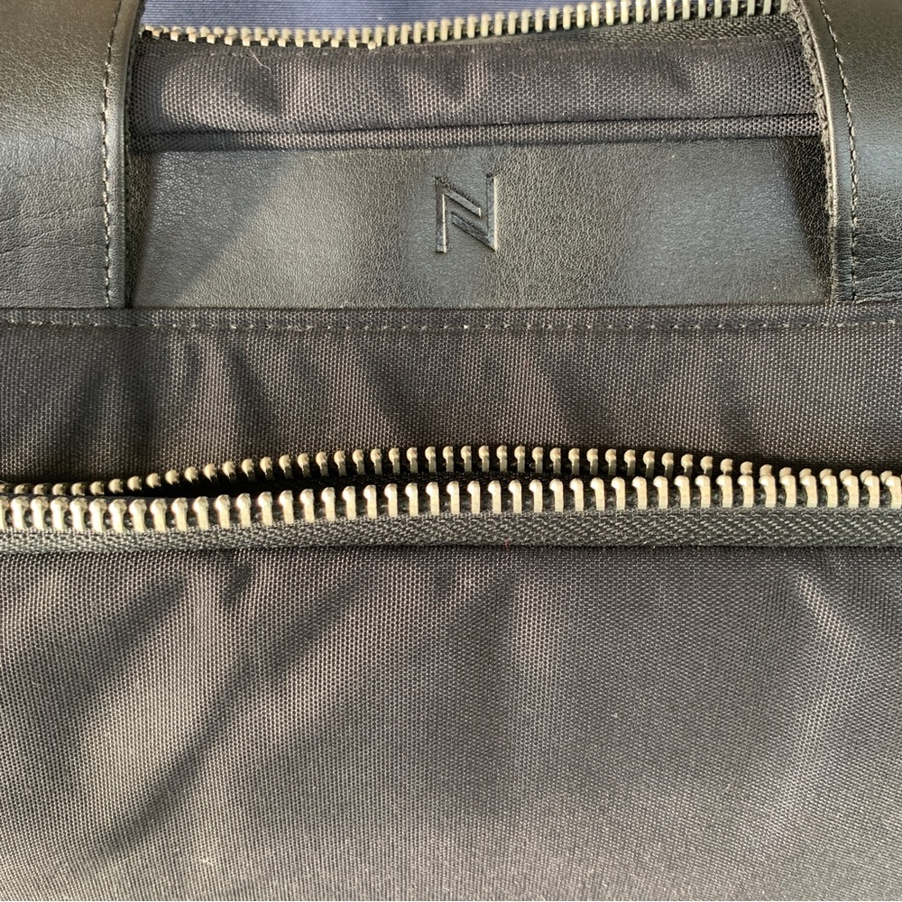 Black Travel Bag with Structured Design and Metal Feet - Picture 12 of 16